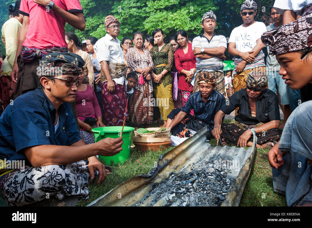 Kuta. Bali. Indonesia. Cremation ceremony. At the end of the cremation, people gather and search the ashes in search of objects Stock Photo