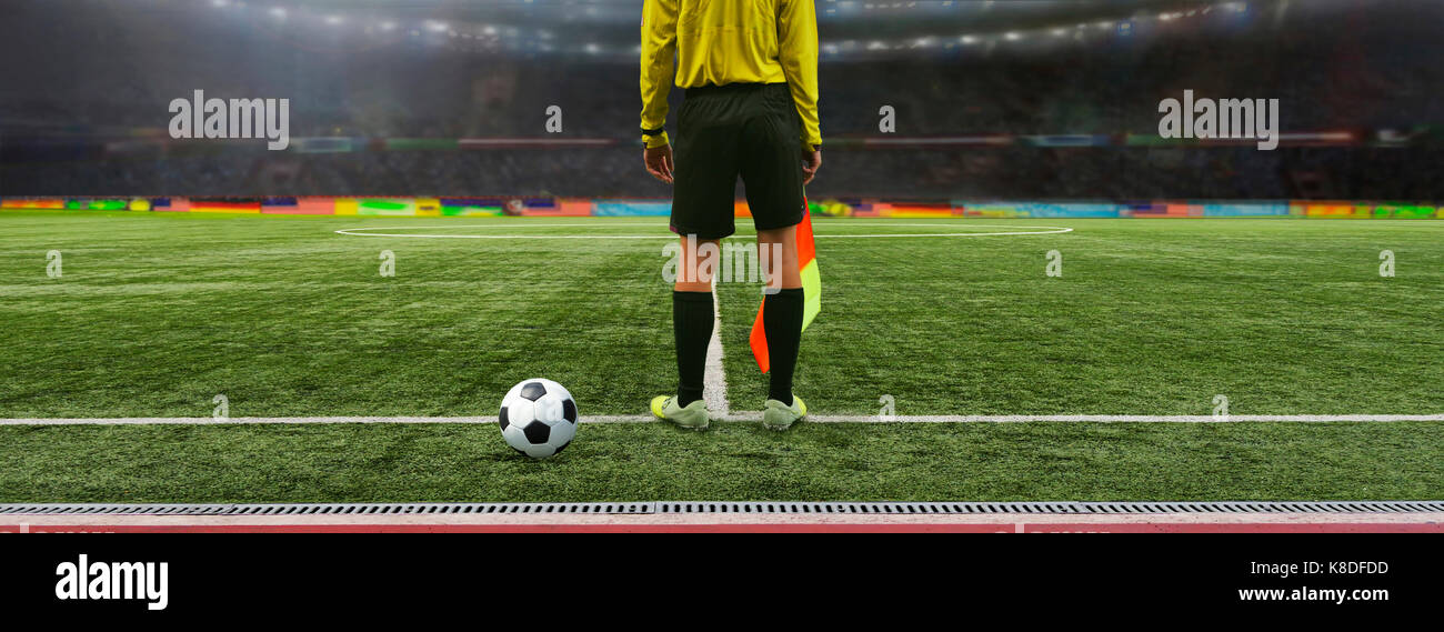 The referee soccer game stands on the field before the game, ready to blow the whistle Stock Photo