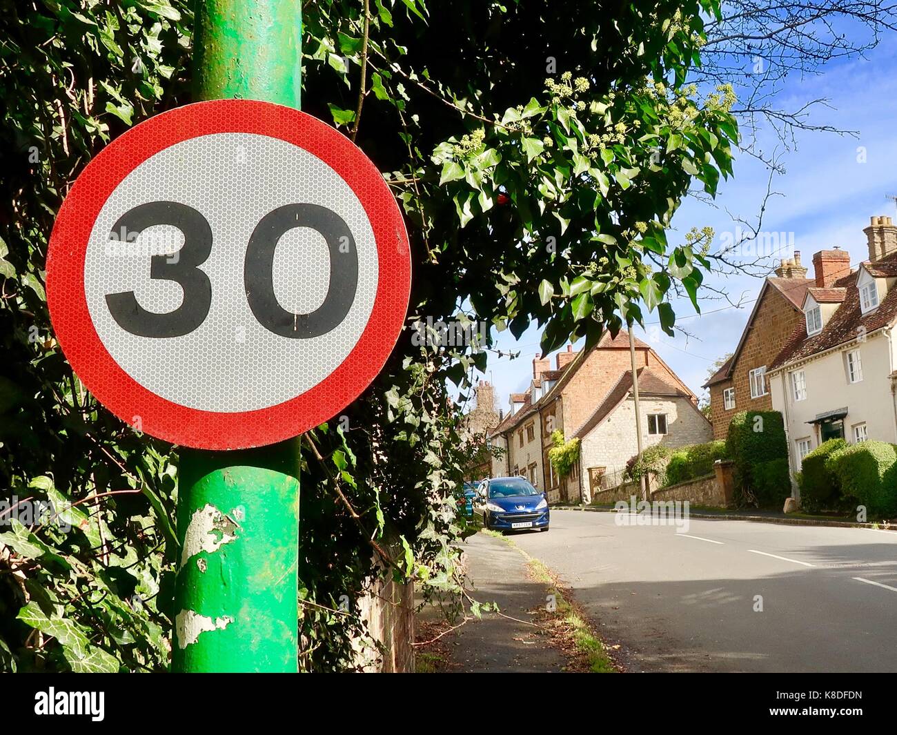 30 MPH speed limit sign on a green post in Kineton, Warwickshire, UK. Stock Photo