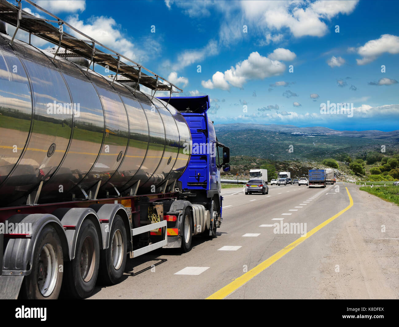 Tanker with chrome tanker on the highway. Working visit Stock Photo