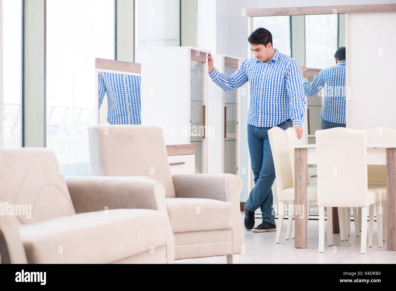 Young man shopping in furniture store Stock Photo - Alamy