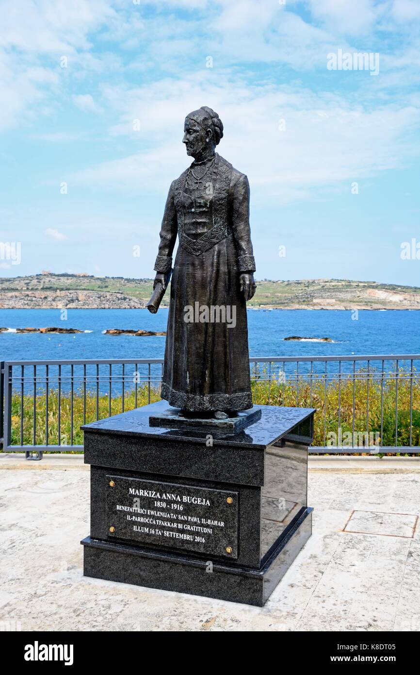 Statue of Markiza Anna Bugeja on the waterfront with views across St Pauls Bay, Bugibba, Malta, Europe. Stock Photo