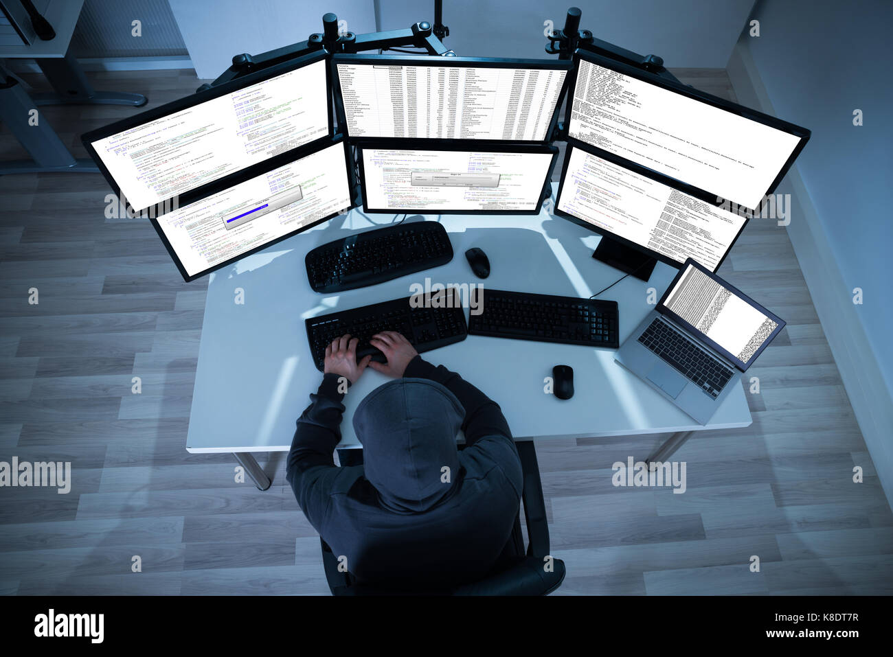 High angle view of hacker using computers to steal data Stock Photo