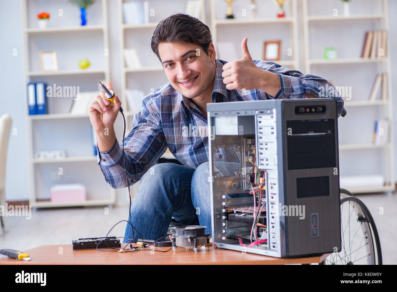 Man repairing pc with thumbs up Stock Photo - Alamy