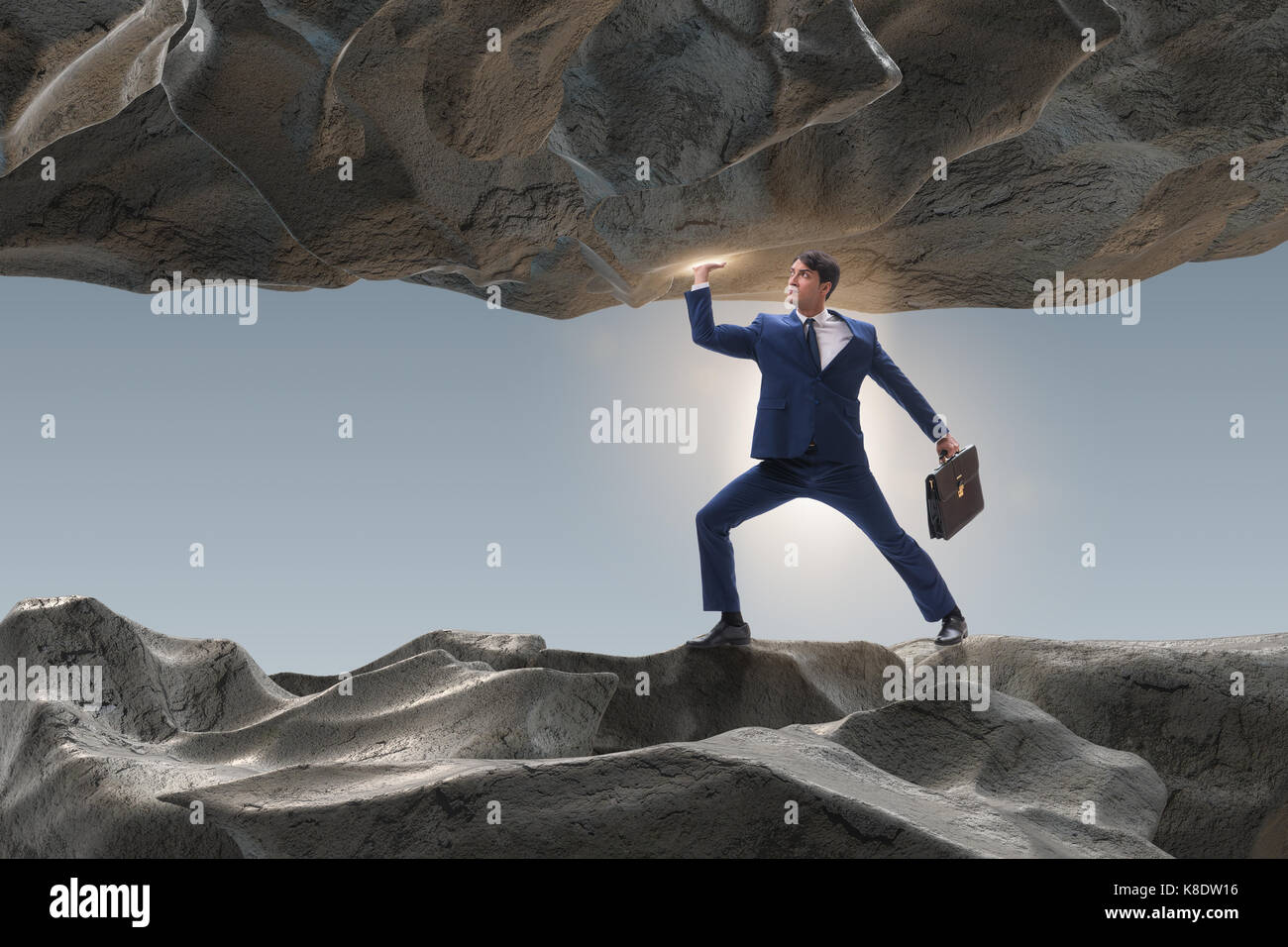 Businessman supporting stone under pressure Stock Photo - Alamy