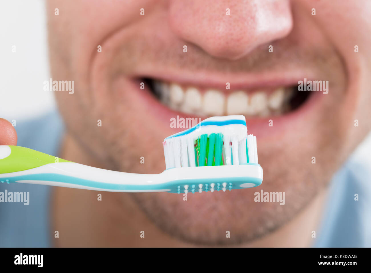 Closeup of mid adult man brushing teeth Stock Photo