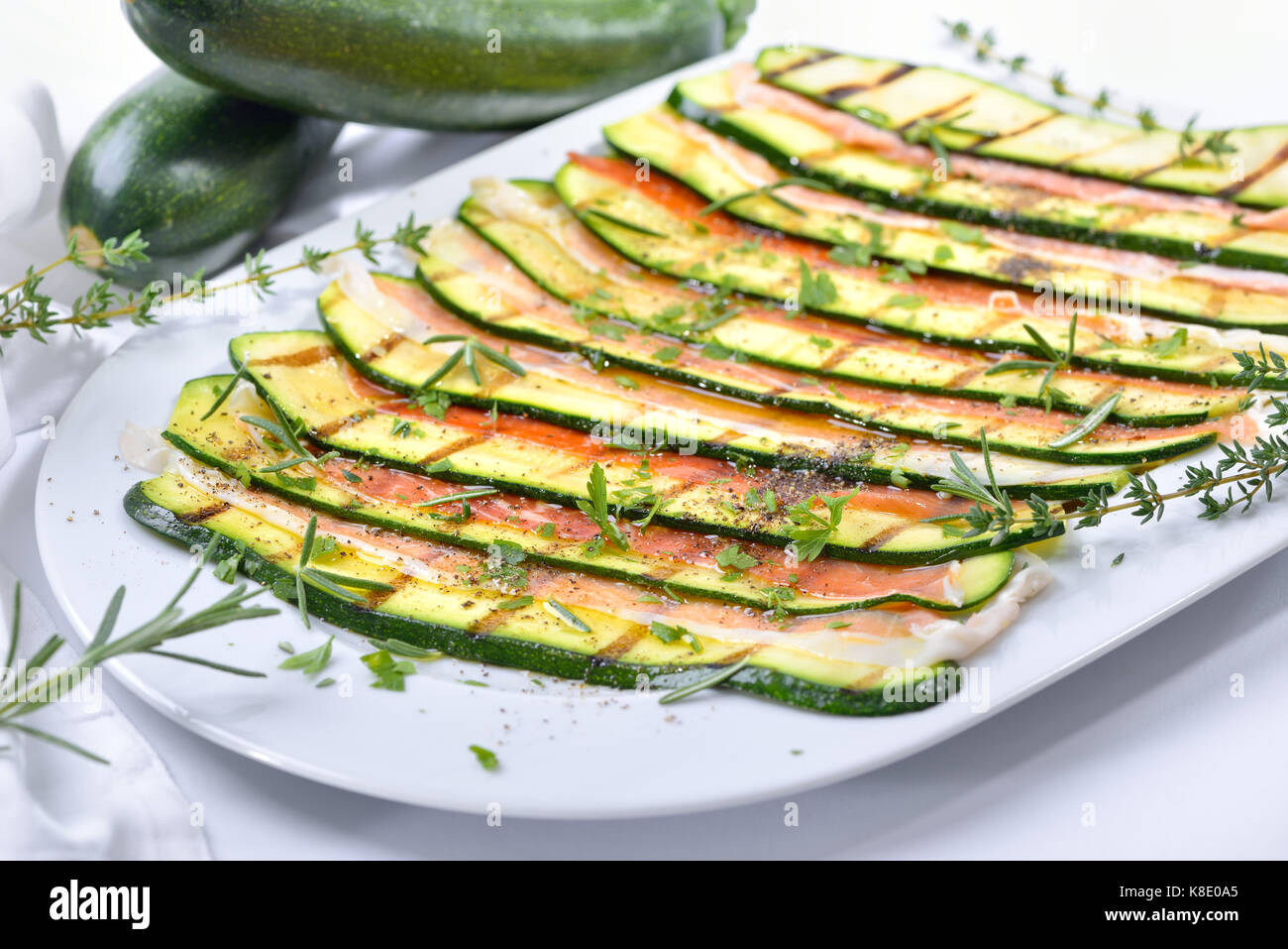 Grilled zucchini slices marinated with olive oil and herbs, served with