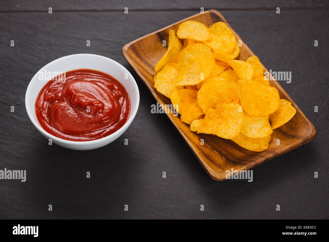 Potato chips and ketchup. Beer snack, unhealthy eating Stock Photo Alamy
