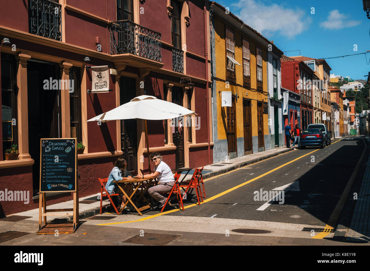 La Laguna, Tenerife, Canary islands, Spain - May 23, 2017. People relax and enjoy their drinks and food at outdoor cafe terrace on colorful street of  Stock Photo