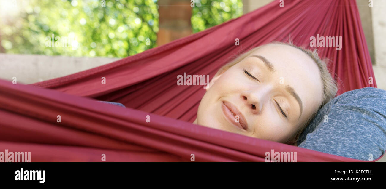 Woman Relaxing In Hammock Stock Photo - Alamy