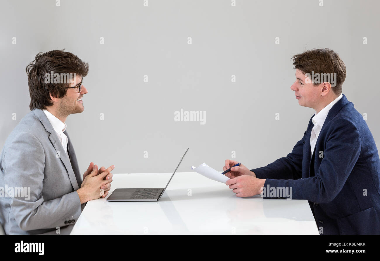 Job interview - businessman listen to candidate answers Stock Photo