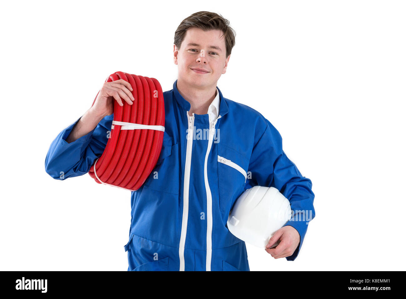 Portrait of confident repairman holding wire roll in bright office Stock Photo