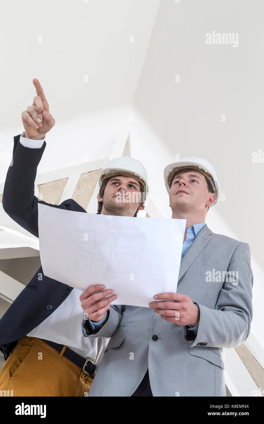 Two Engineer or Architect discuss on Project at renovation Construction Stock Photo