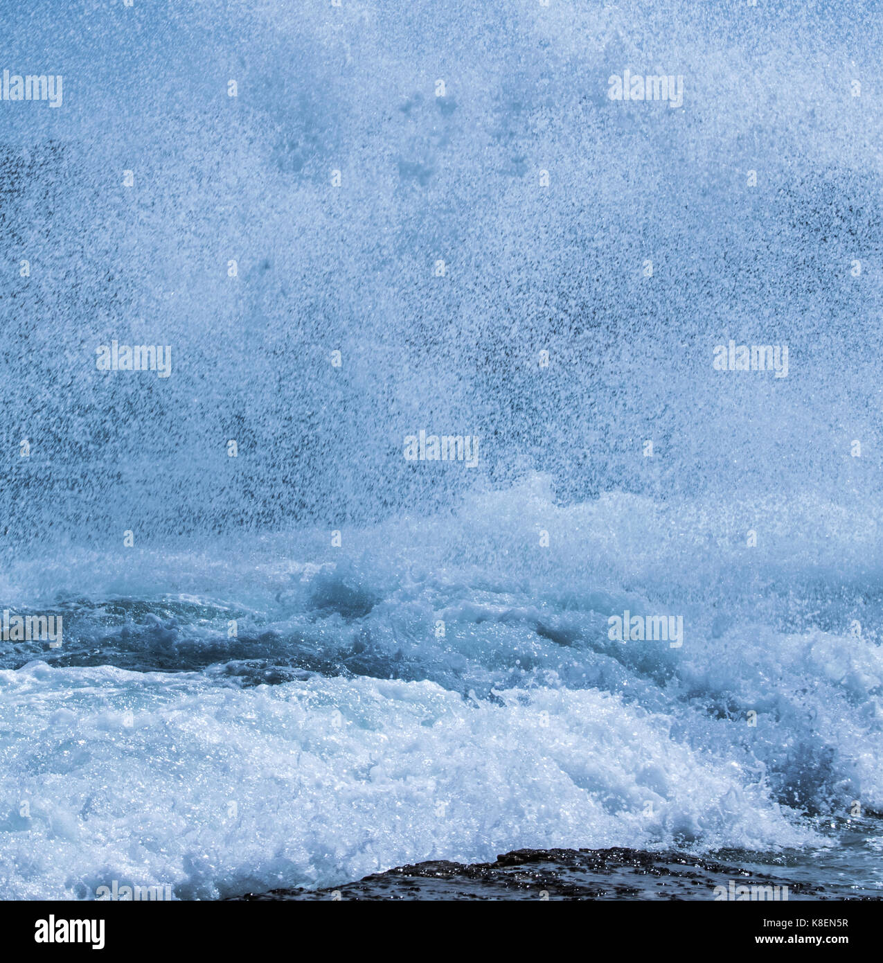 A close look at a wave splashing on the rocks Stock Photo - Alamy