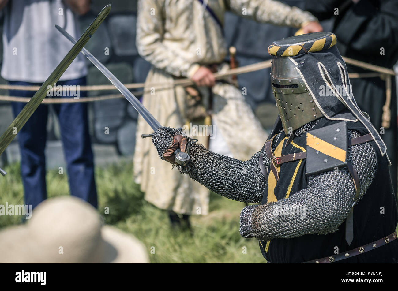 MOSCOW,RUSSIA-June 06,2016: Martial duel of two medieval teutonic warriors. Knights in full armour fight with swords on arena. Stock Photo