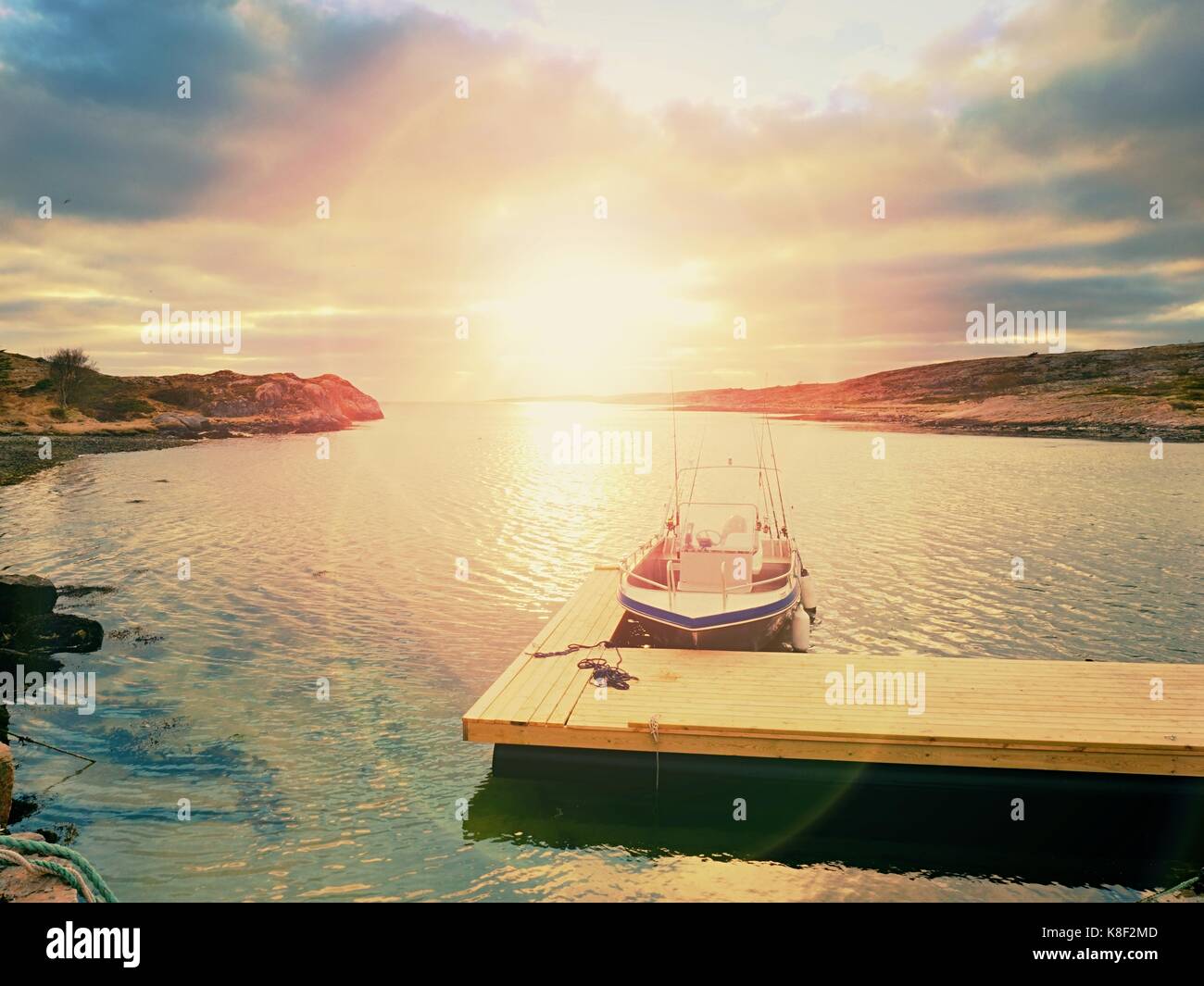 Fishing boat in bay port, sunset calm water. A motorboat for sport