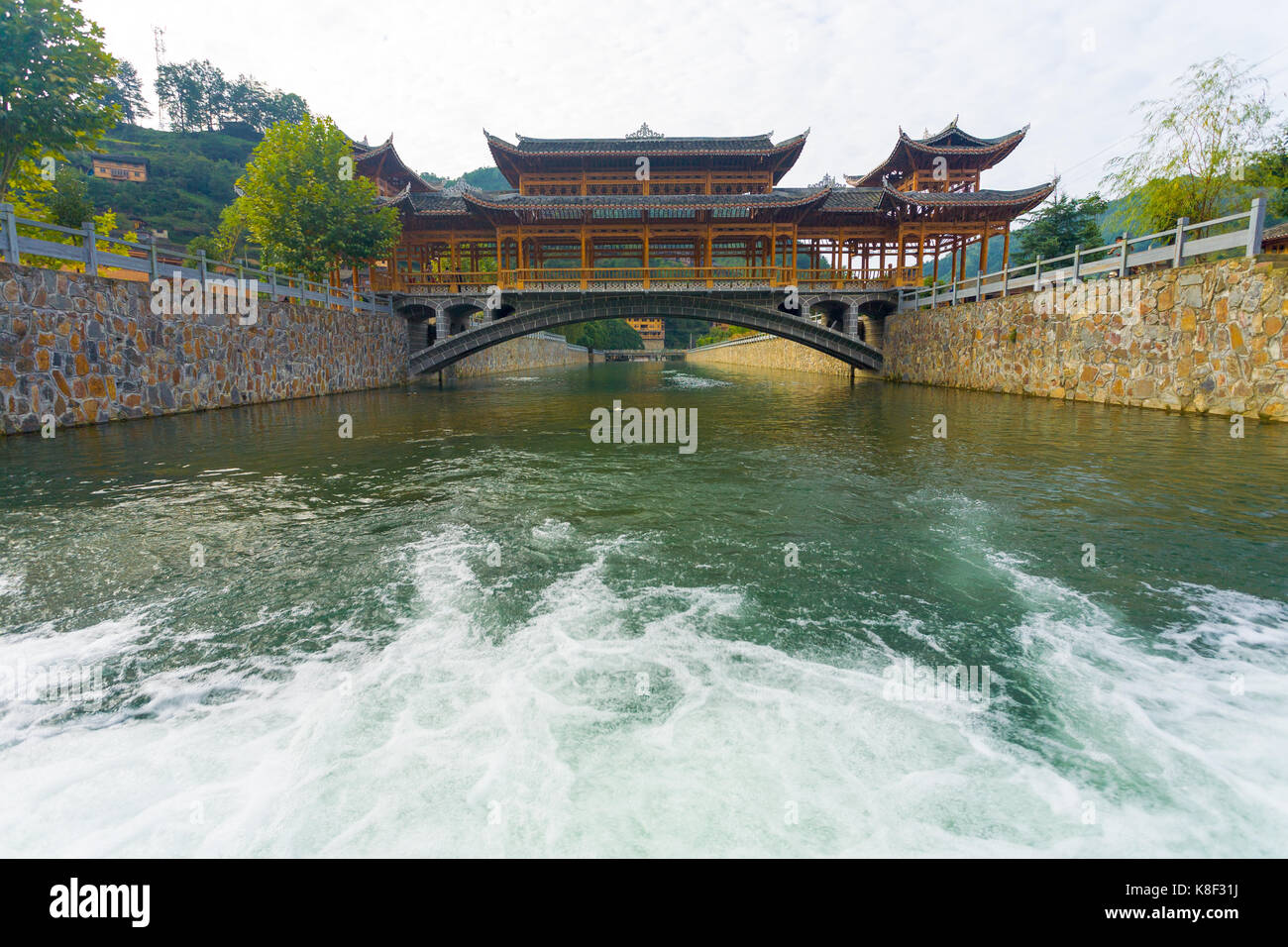 Low angle view of the traditional wooden bridge at Xijiang Miao ethnic minority village in Guizhou, China Stock Photo