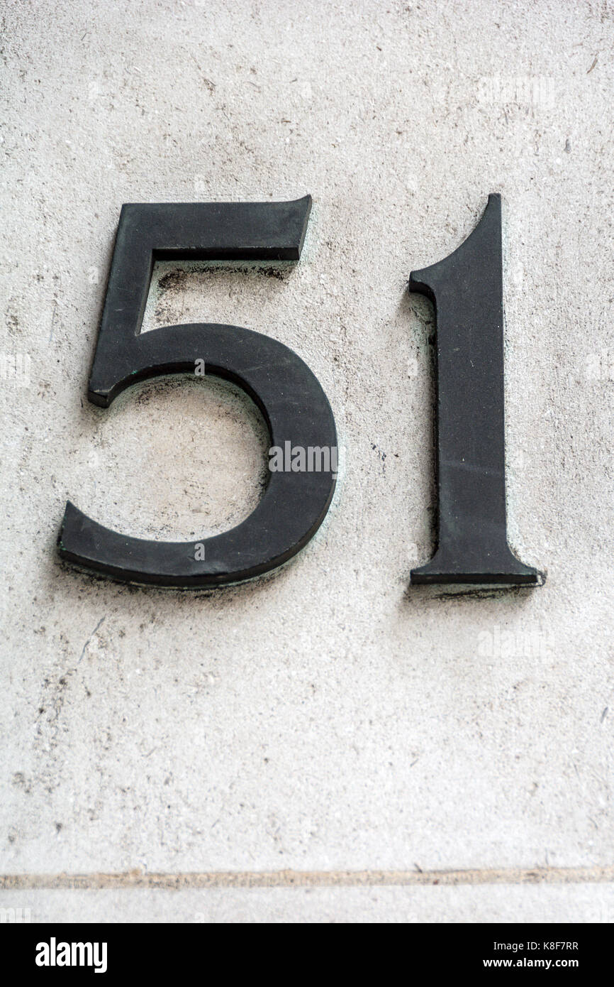 Number fifty one in dark figures on white wall Stock Photo