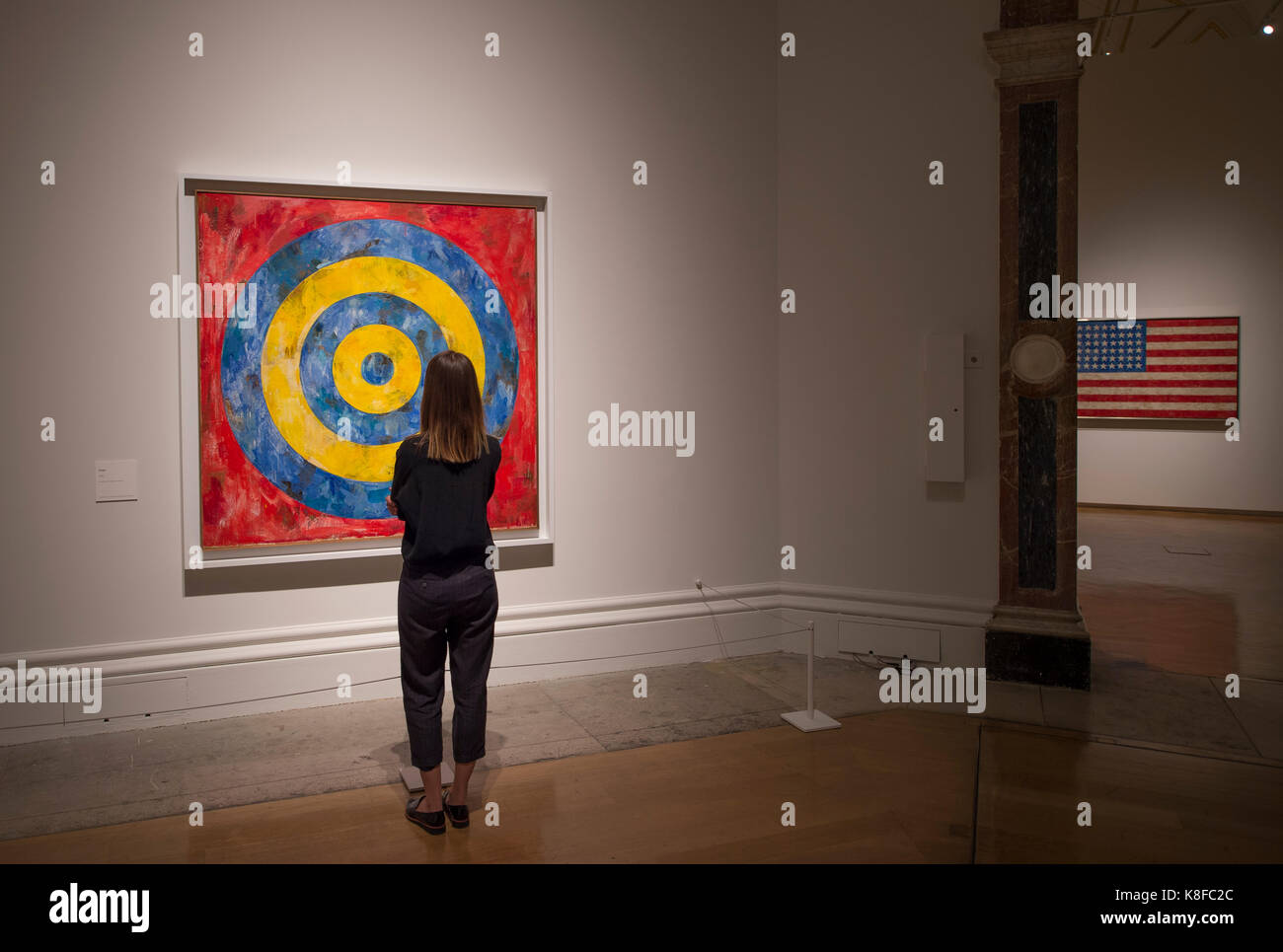 Royal Academy of Arts, London, UK. 19 September 2017. The RA presents a landmark exhibition of the Honorary Royal Academician, Jasper Johns, the first comprehensive survey of the artist's work to be held in the UK for 40 years. The exhibition runs from 23 September - 10 December 2017. Photograph (left to right): Target, 1961. The Art Institute of Chicago; Flag, 1958. Private collection.  Viewed by a member of gallery staff. Credit: Malcolm Park/Alamy Live News. Stock Photo