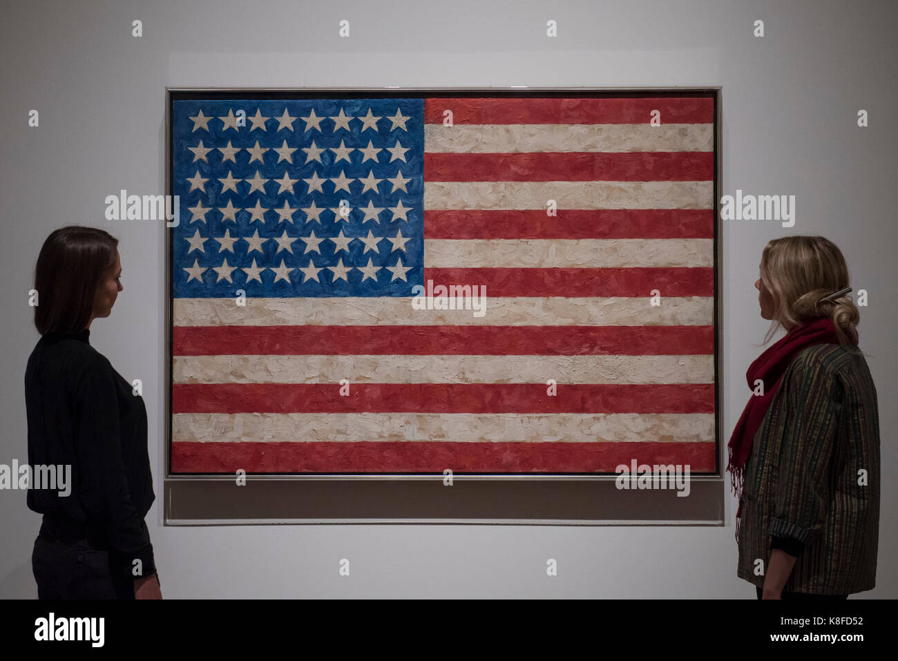 London, UK.  19 September 2017.  Staff members view 'Flag', 1958, by Jasper Johns.  Preview of a landmark exhibition by Jasper Johns RA called 'Something Resembling Truth' at the Royal Academy of Arts in Piccadilly.  Sculptures, drawing, prints plus new works are on display 25 September to 10 December 2017.  Credit: Stephen Chung / Alamy Live News Stock Photo