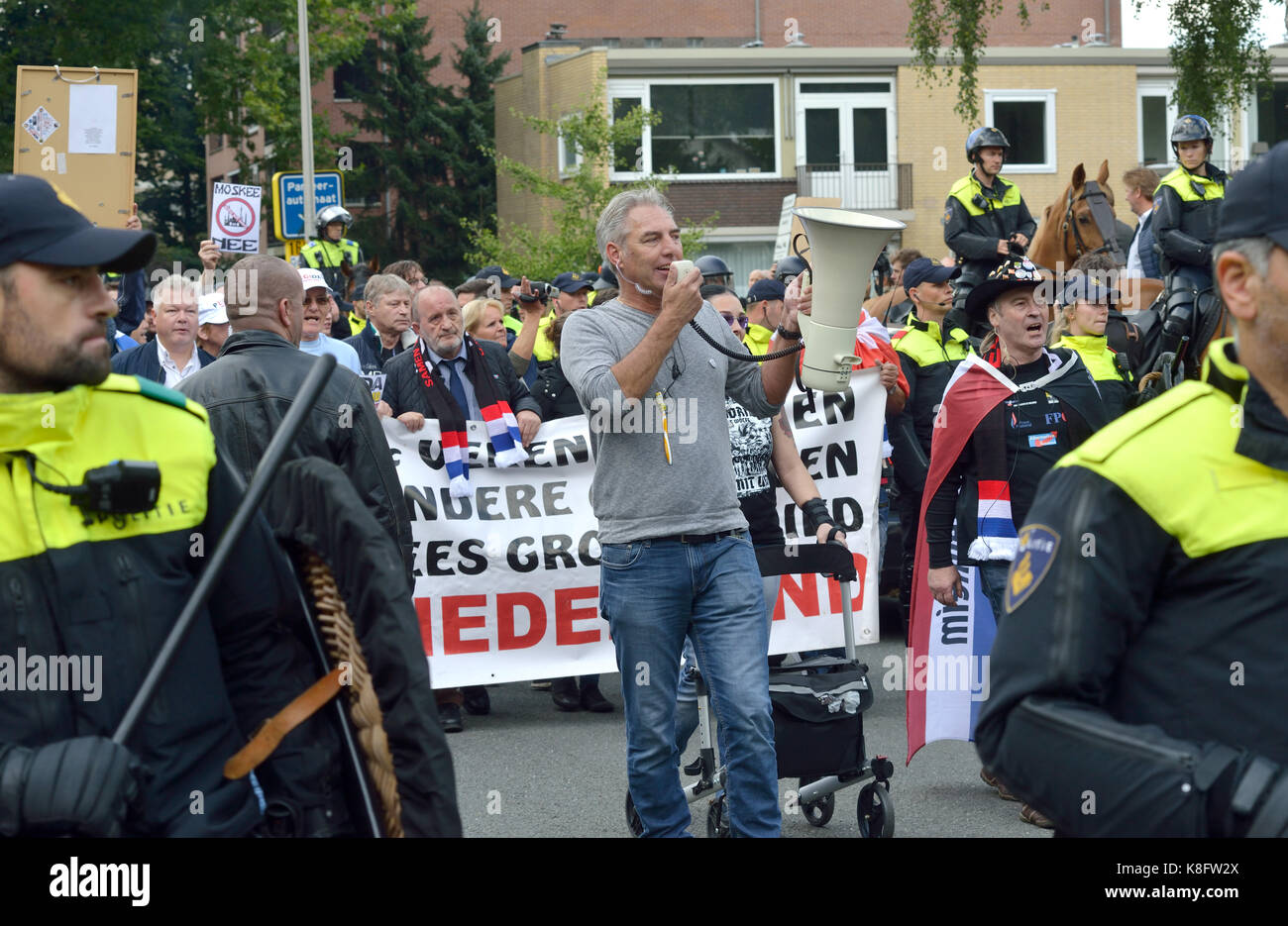 People are protesting during an anti islam demonstration of Pegida. Pegida is a group of people who are against islamization of Europe. Stock Photo
