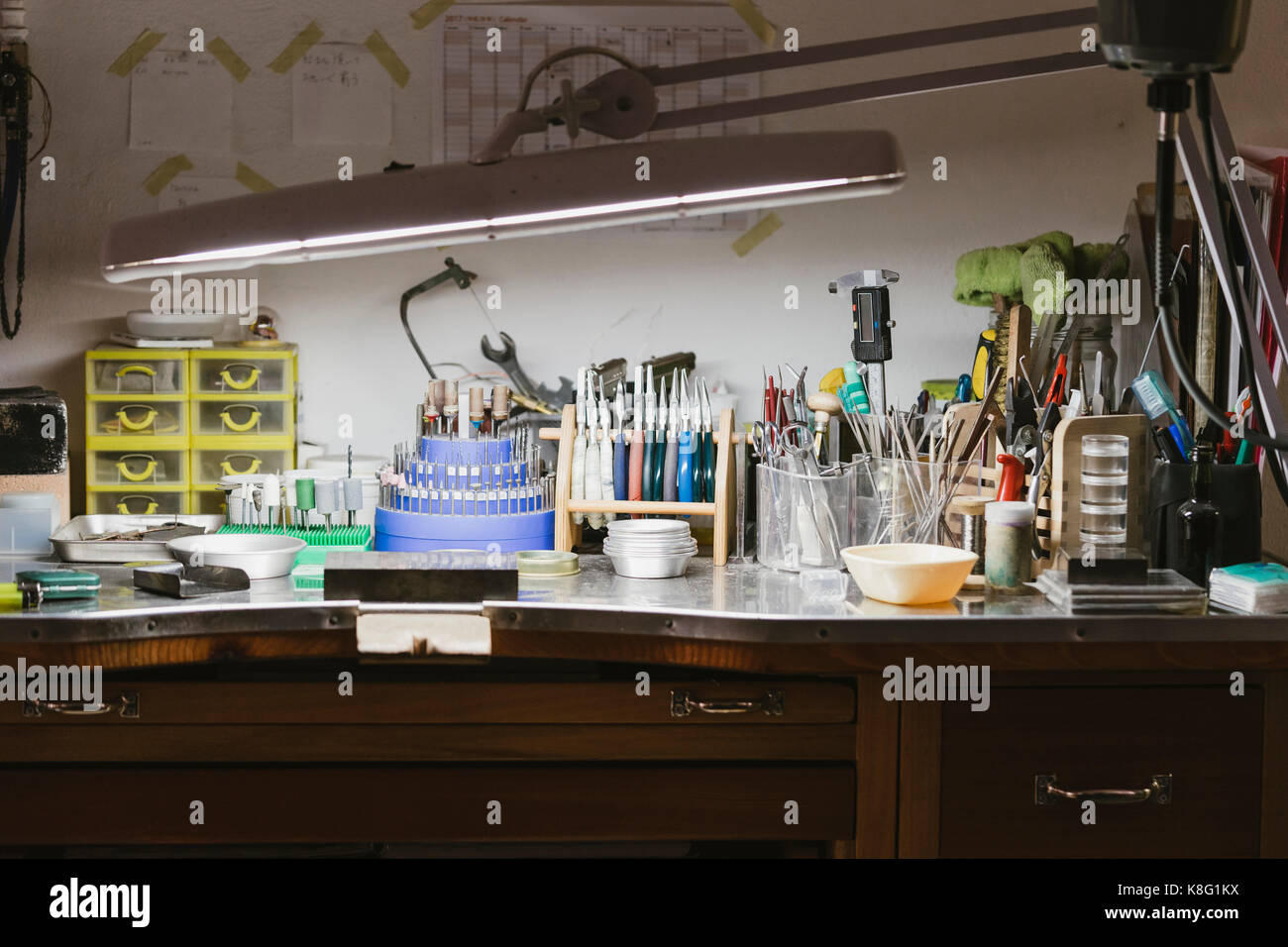 Illuminated Jewellers Workbench In Jewellery Workshop Stock Photo