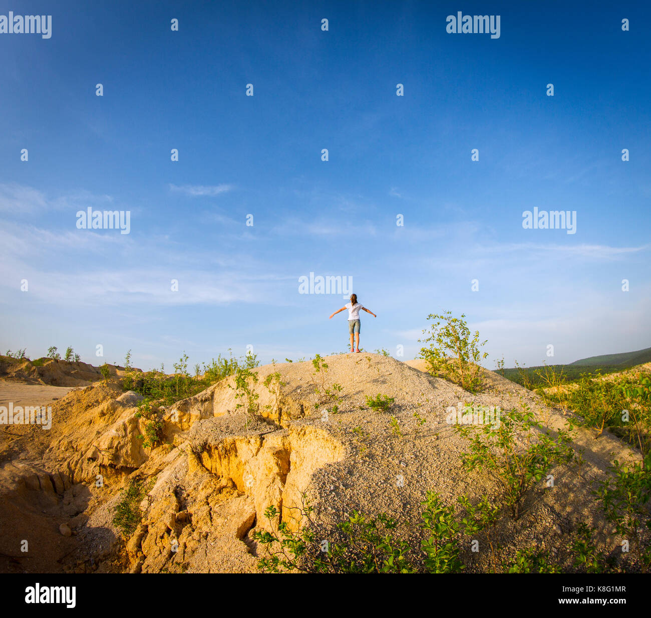 Rear view of teenage girl standing on top of quarry Stock Photo