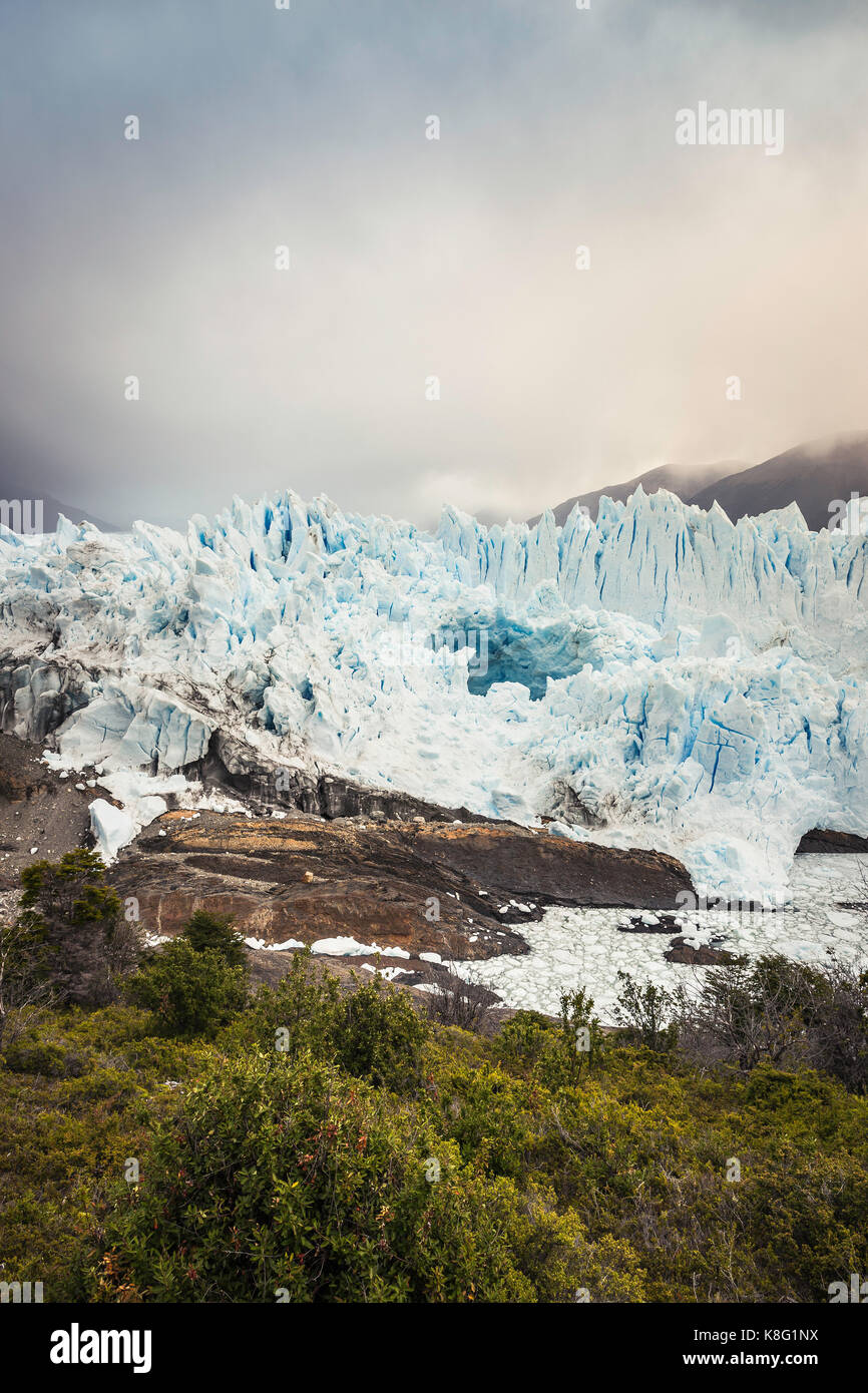 View of Perito Moreno Glacier and storm cloud over mountains, Los Glaciares National Park, Patagonia, Chile Stock Photo