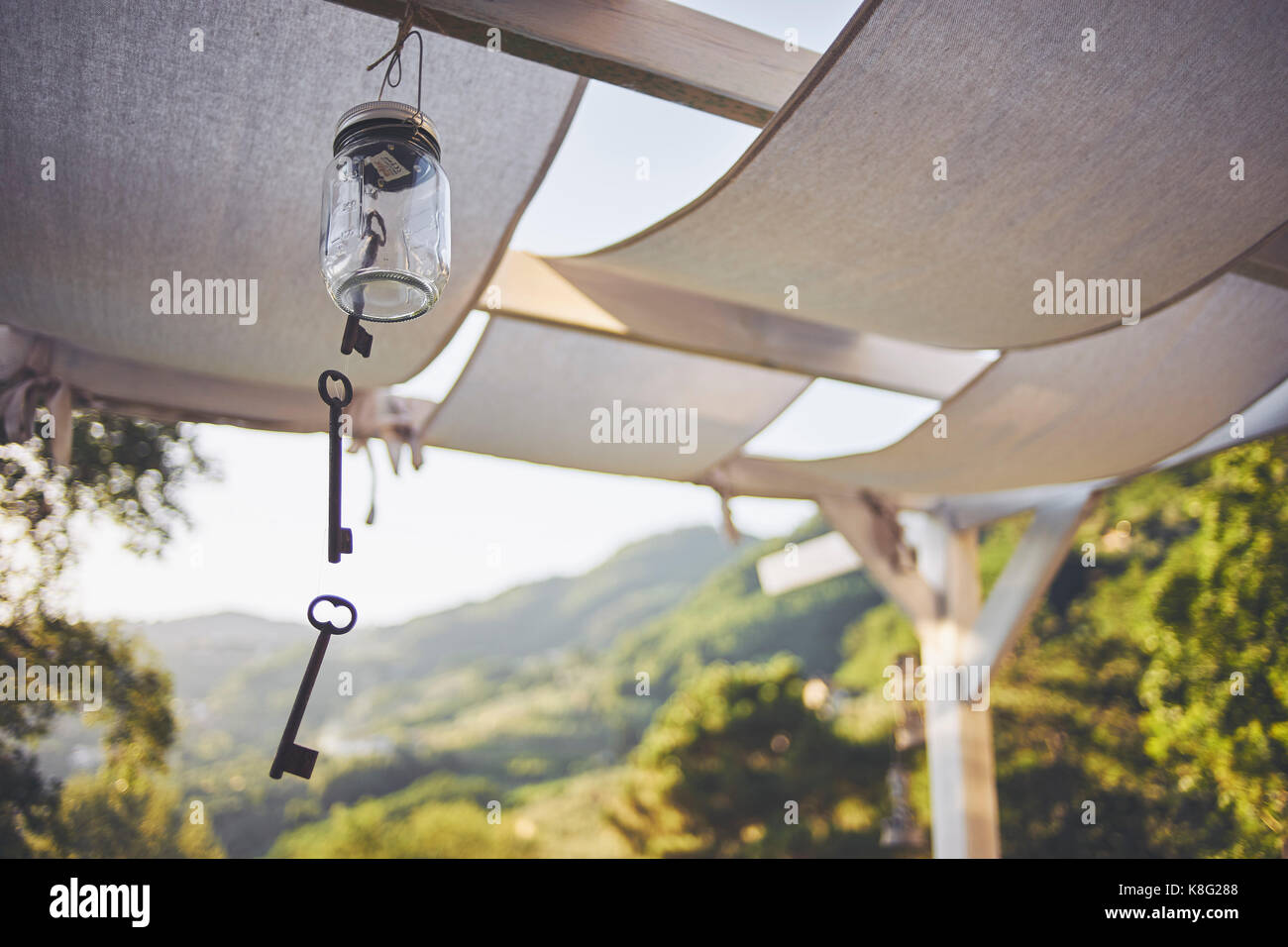 Key wind chime hanging from patio rafter, Lucca, Tuscany, Italy Stock Photo