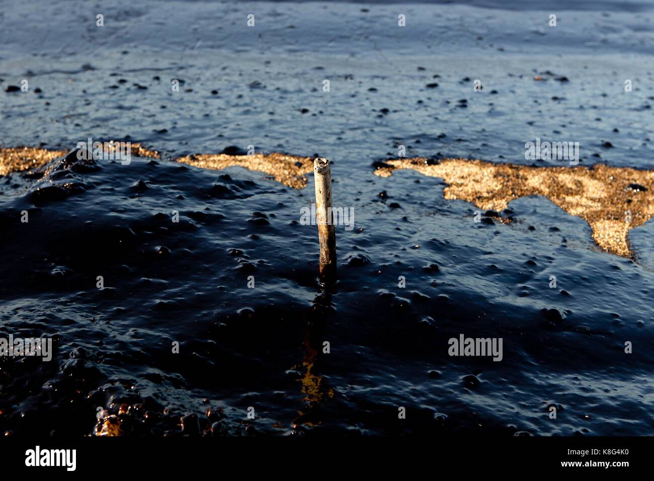 Greek officials traded accusations Wednesday after an oil spill from a sunken tanker drifted to other parts of the Saronic Gulf in Athens. The 45-year Stock Photo