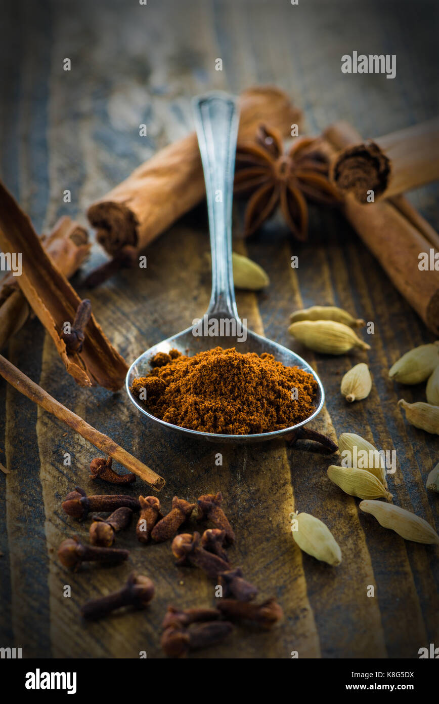 Spices - cinnamon, cloves and cardamom on wooden table - closeup with selective focus Stock Photo