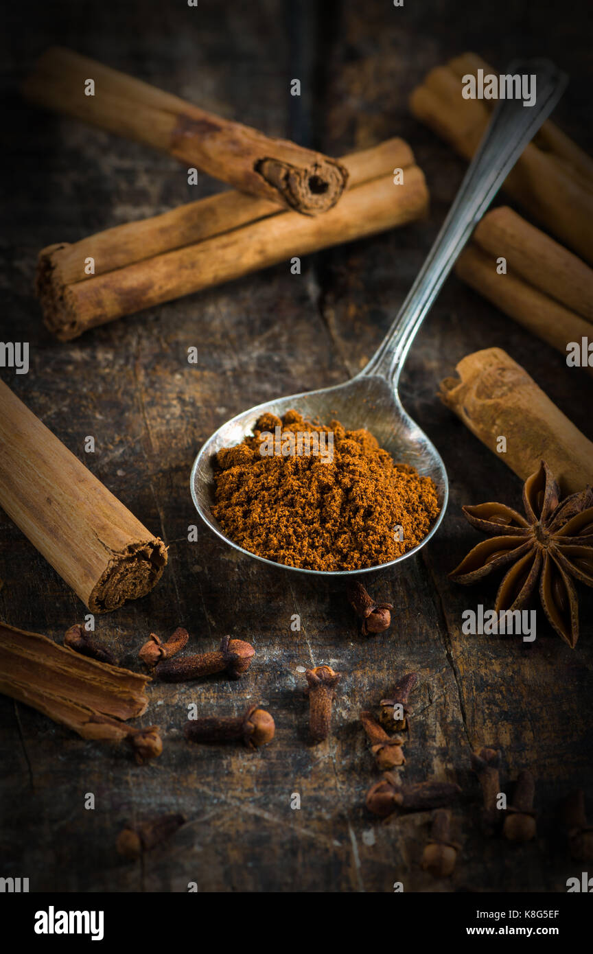 Spices - cinnamon and cloves on wooden table - closeup with selective focus Stock Photo