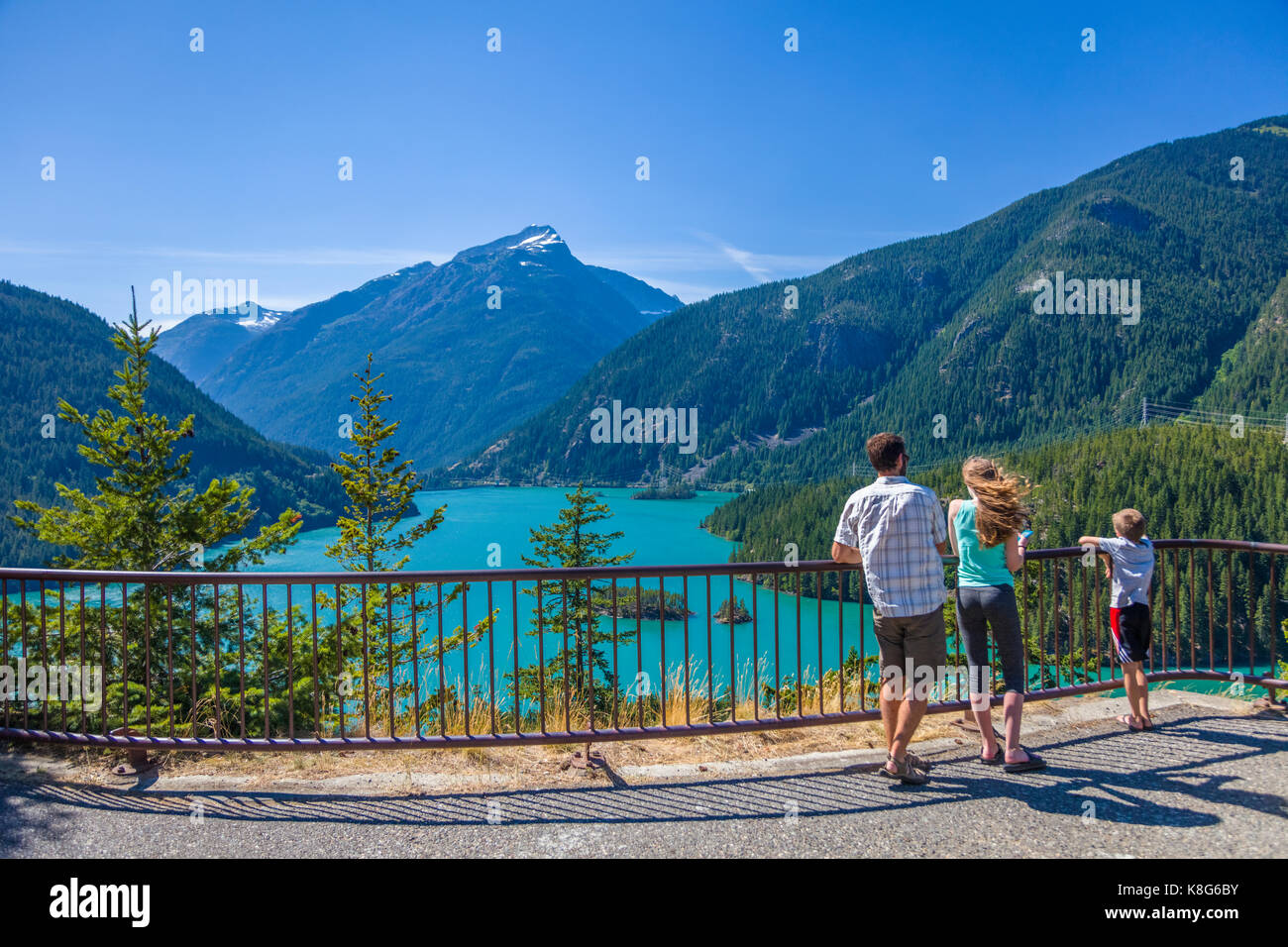 Man, Woman and child looking at Diablo Lake in North Cascades National Park in Northwest Washington State Stock Photo