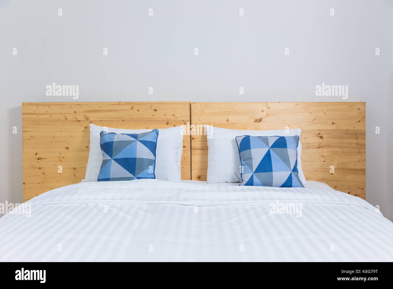 Empty Cozy White Bed With Blue And White Pillows And Wooden Headboard Stock Photo Alamy