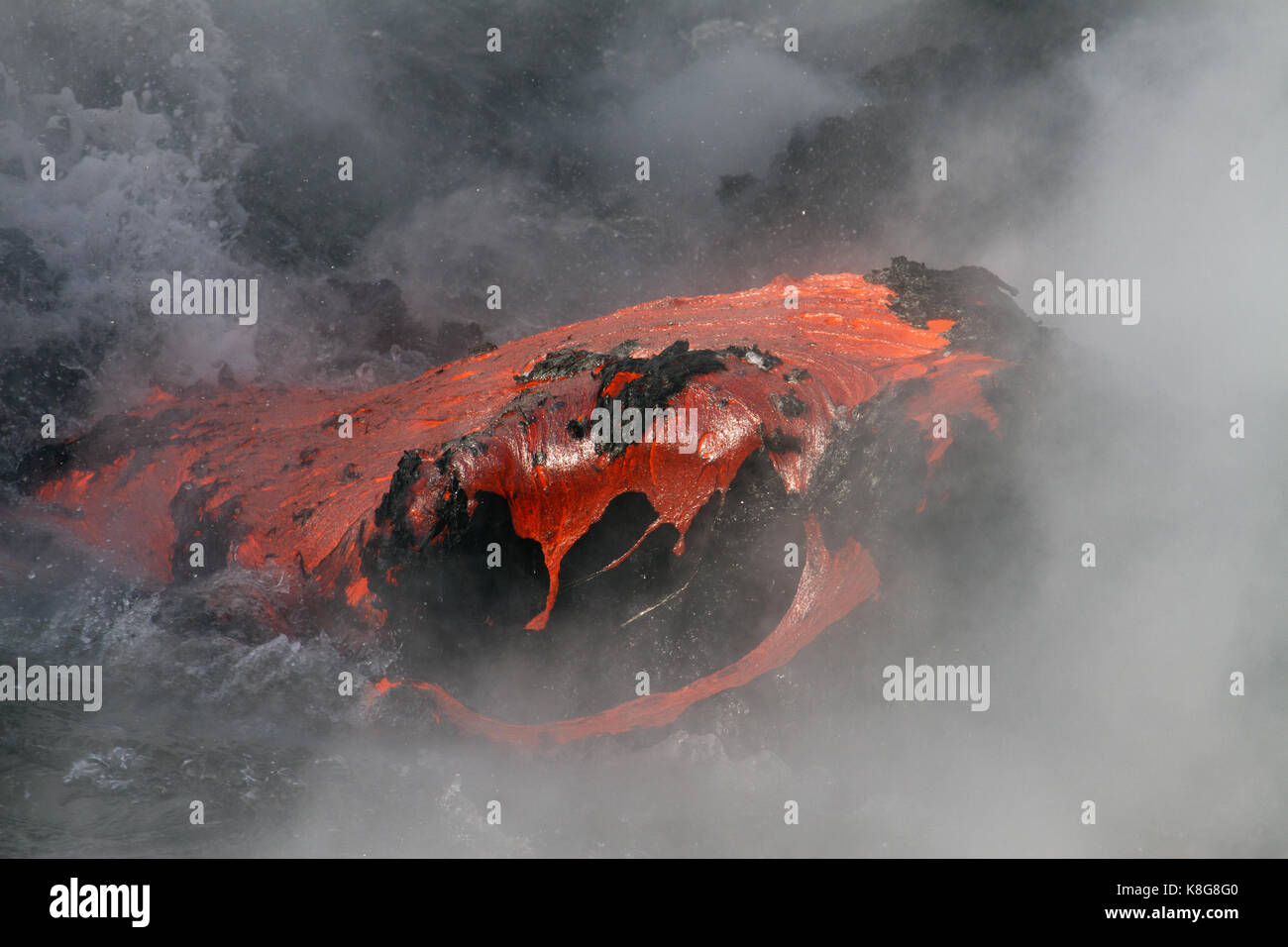 Lava flow enters the sea in Hawaii Stock Photo