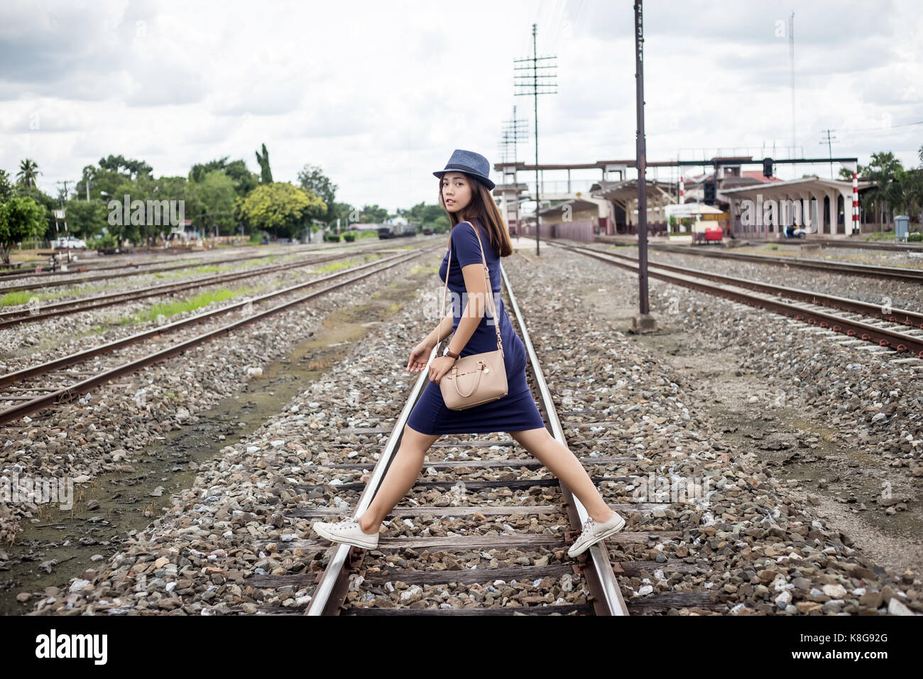 asian thai lady walking on railway on journy concept in summer Stock Photo