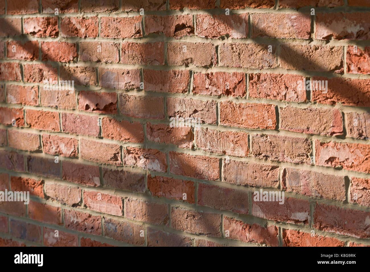 York Old Clamp red brick wall with scaffolding tube shadows Stock Photo