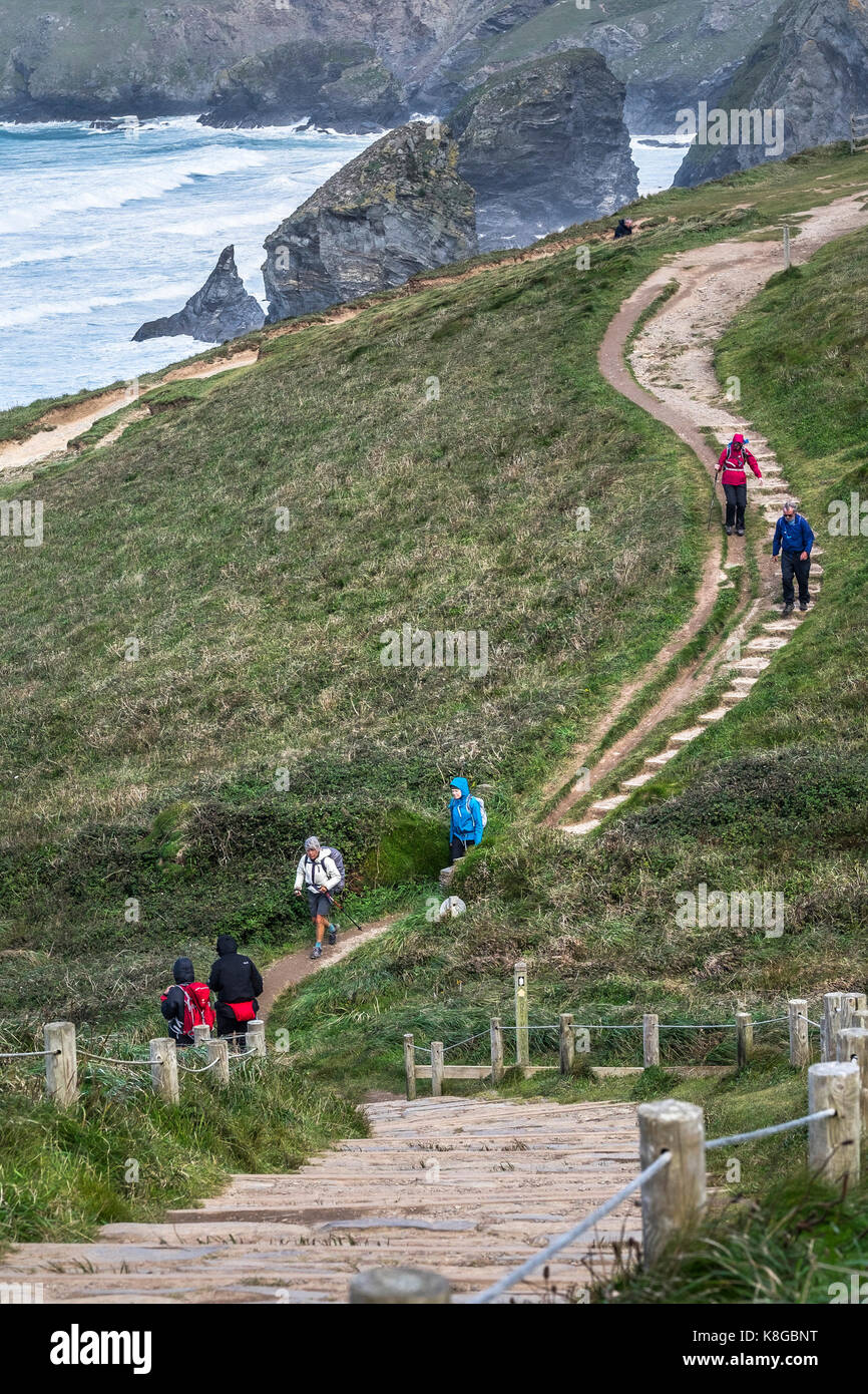 Bedruthan Steps - Walkers climbing up and down steep steps on the South West Coast Path at Bedruthan Steps on the North Cornwall coast. Stock Photo