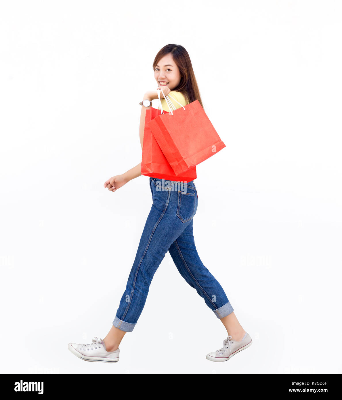 asian thai lady hold shopping paper bag is cheerful target customer on white isolate Stock Photo
