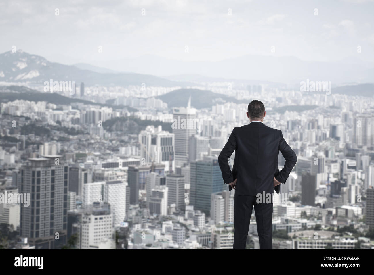 man in suit looking to cityscape,Business concept Stock Photo