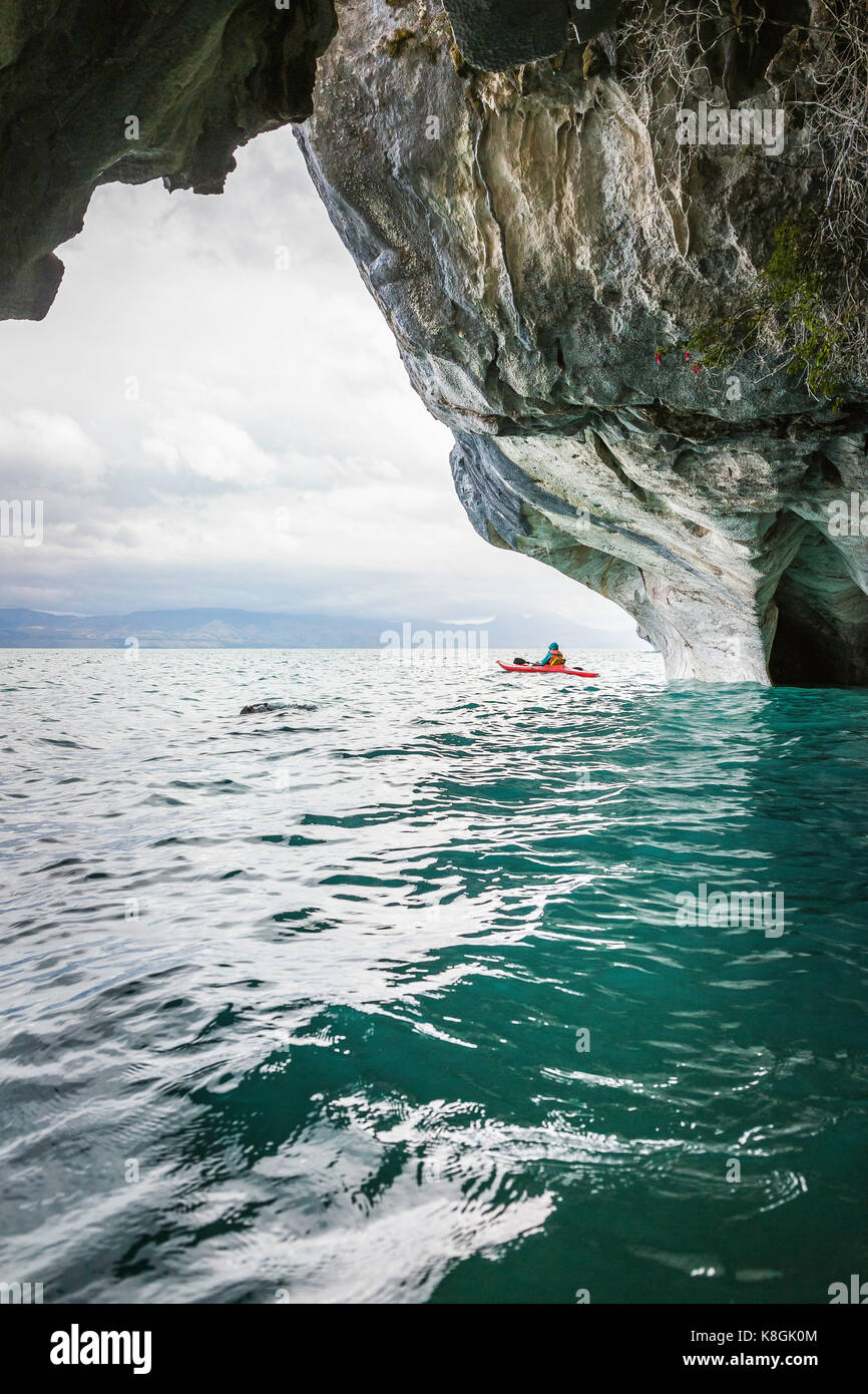 Woman kayaking around marble caves, Puerto Tranquilo, Aysen Region, Chile, South America Stock Photo