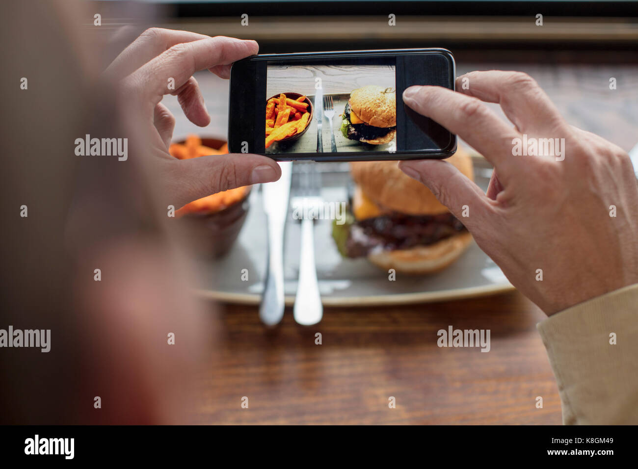 Man photographing food with smartphone Stock Photo