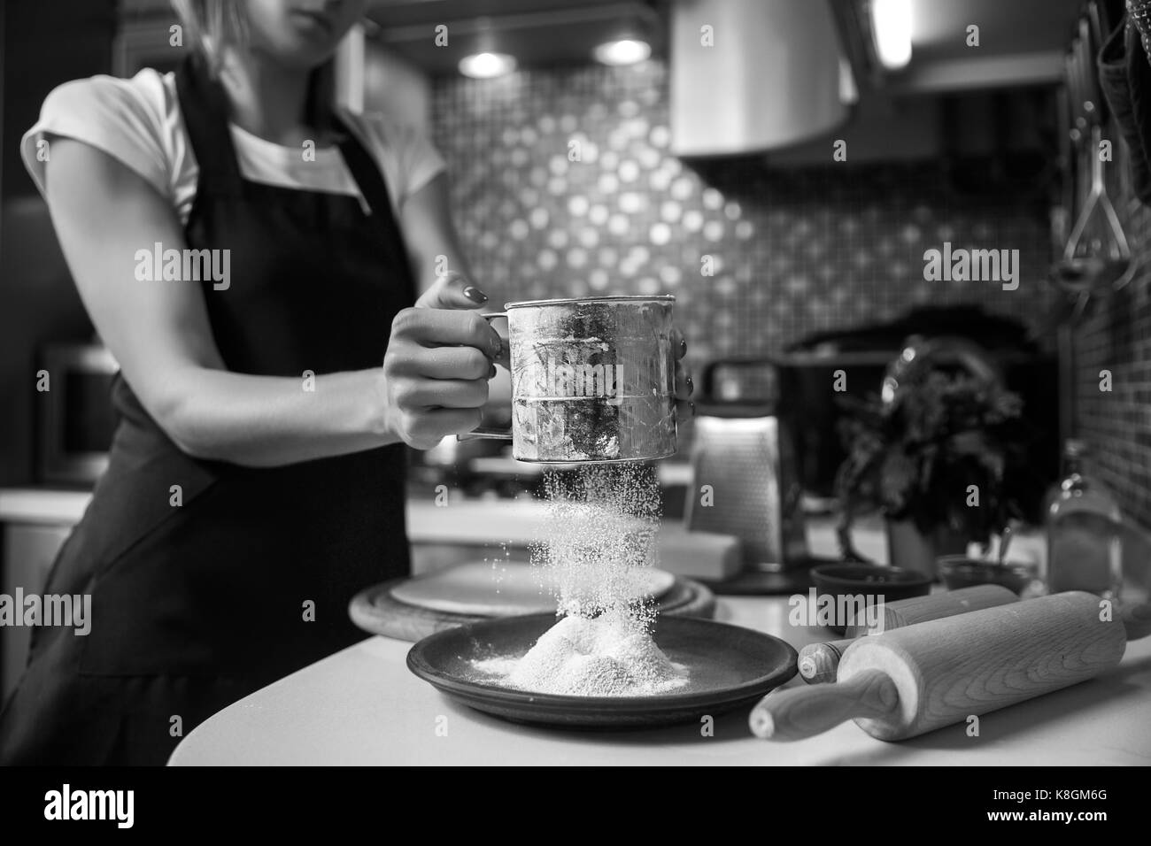 Woman sifting flour through sieve. Selective focus Stock Photo Alamy