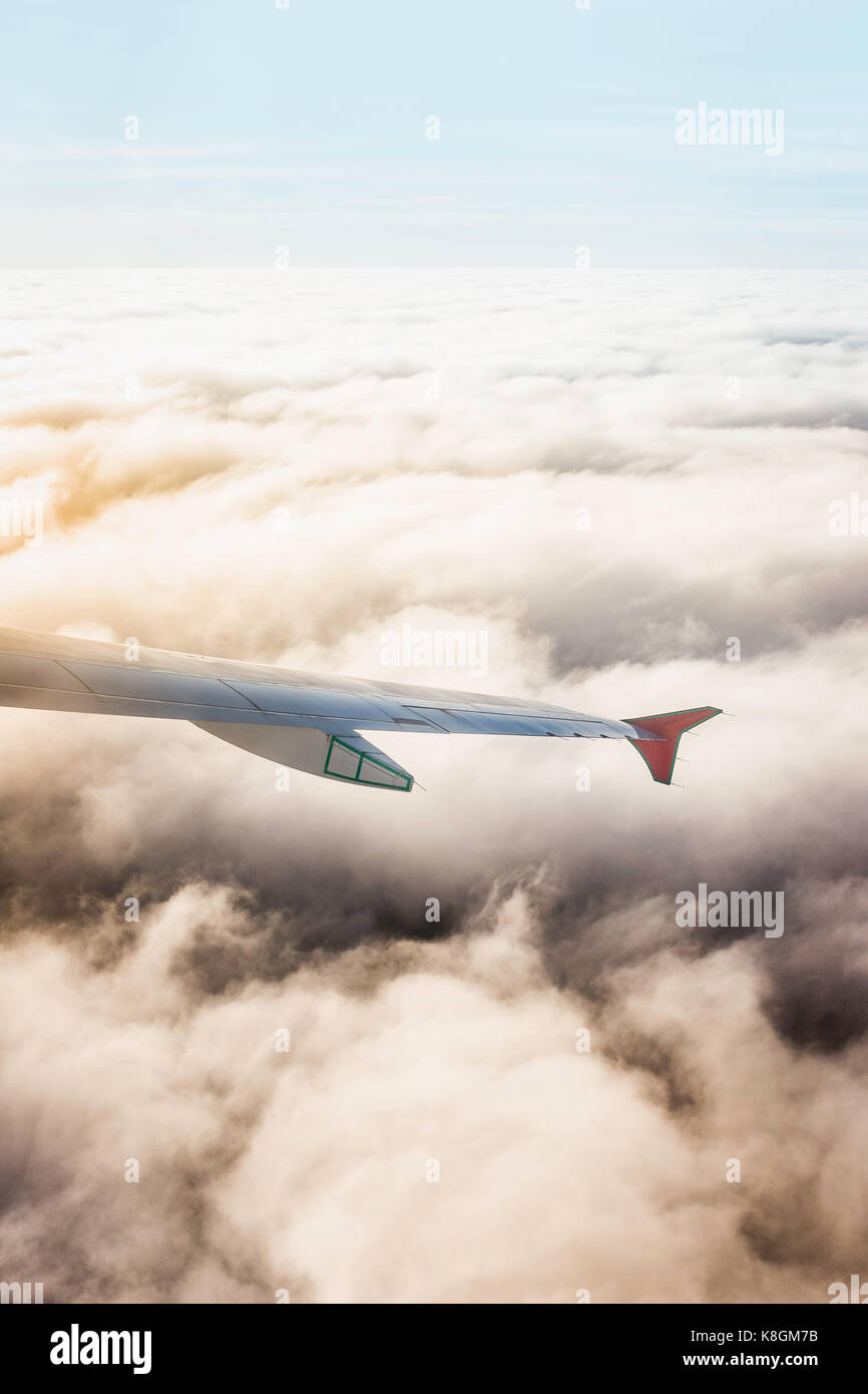 Airplane wing above the clouds Stock Photo - Alamy