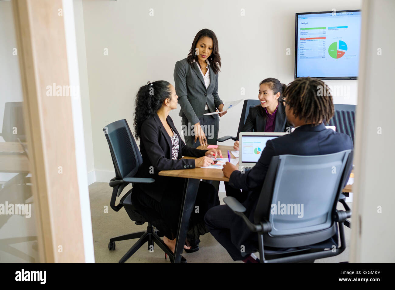 Businessman and businesswomen, sitting in office, having discussion Stock Photo