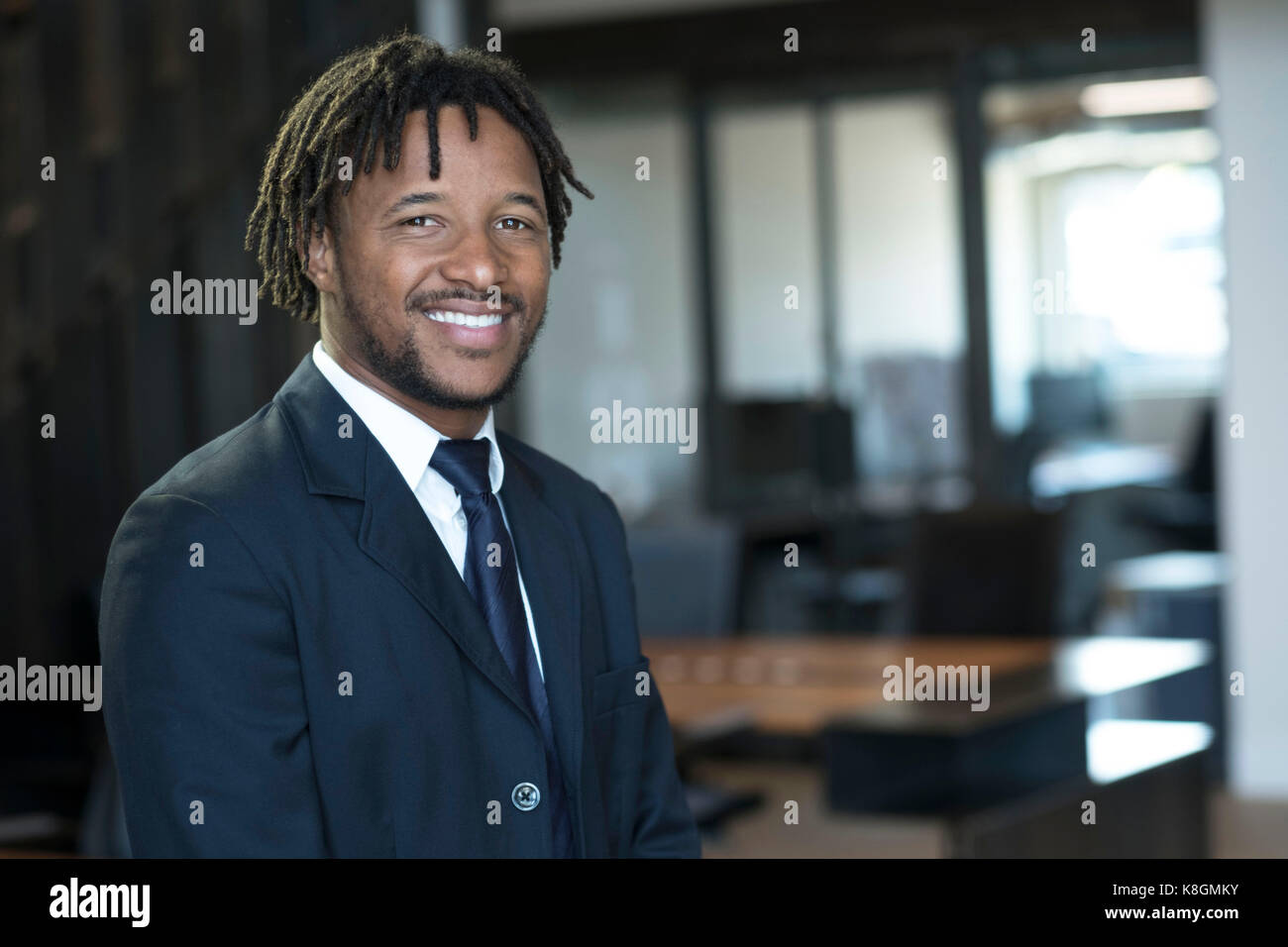 Portrait of young businessman in office, smiling Stock Photo