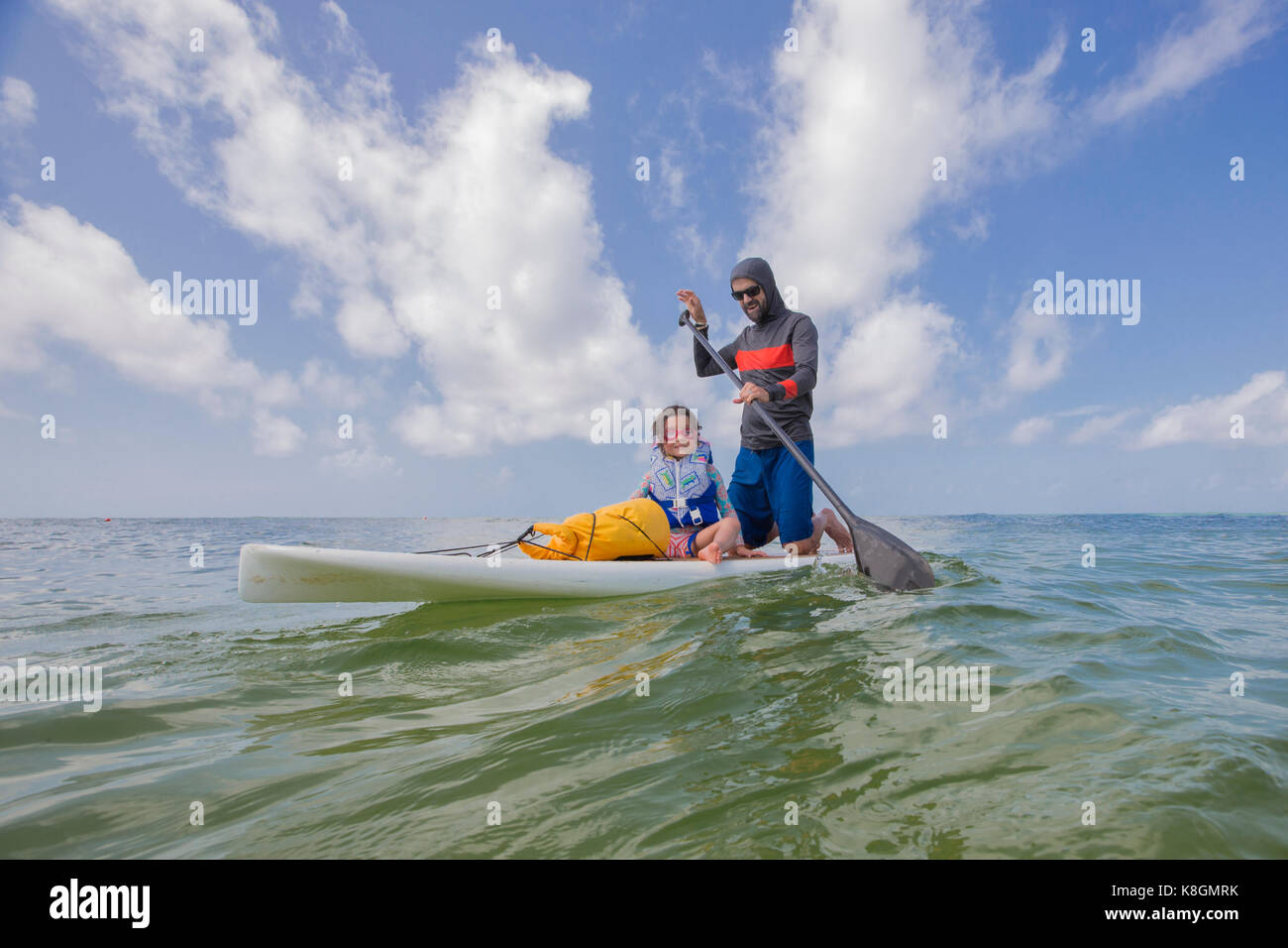 Father and daughter paddle boarding in the Gulf of Mexico, Destin
