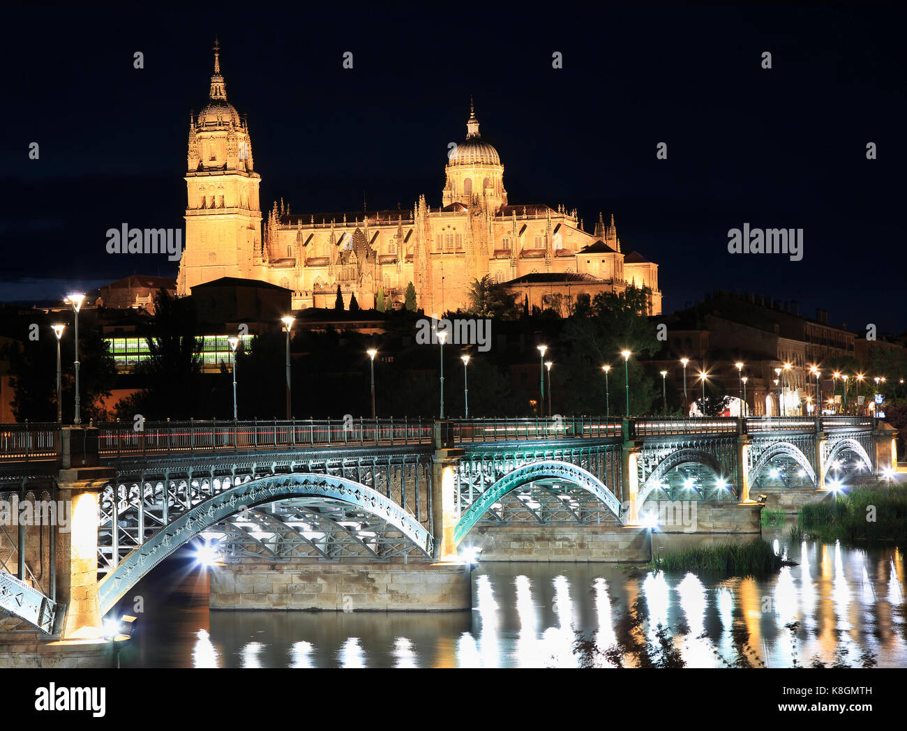 Salamanca skyline at night and Enrique Esteban Bridge over Tormes River in Spain Stock Photo