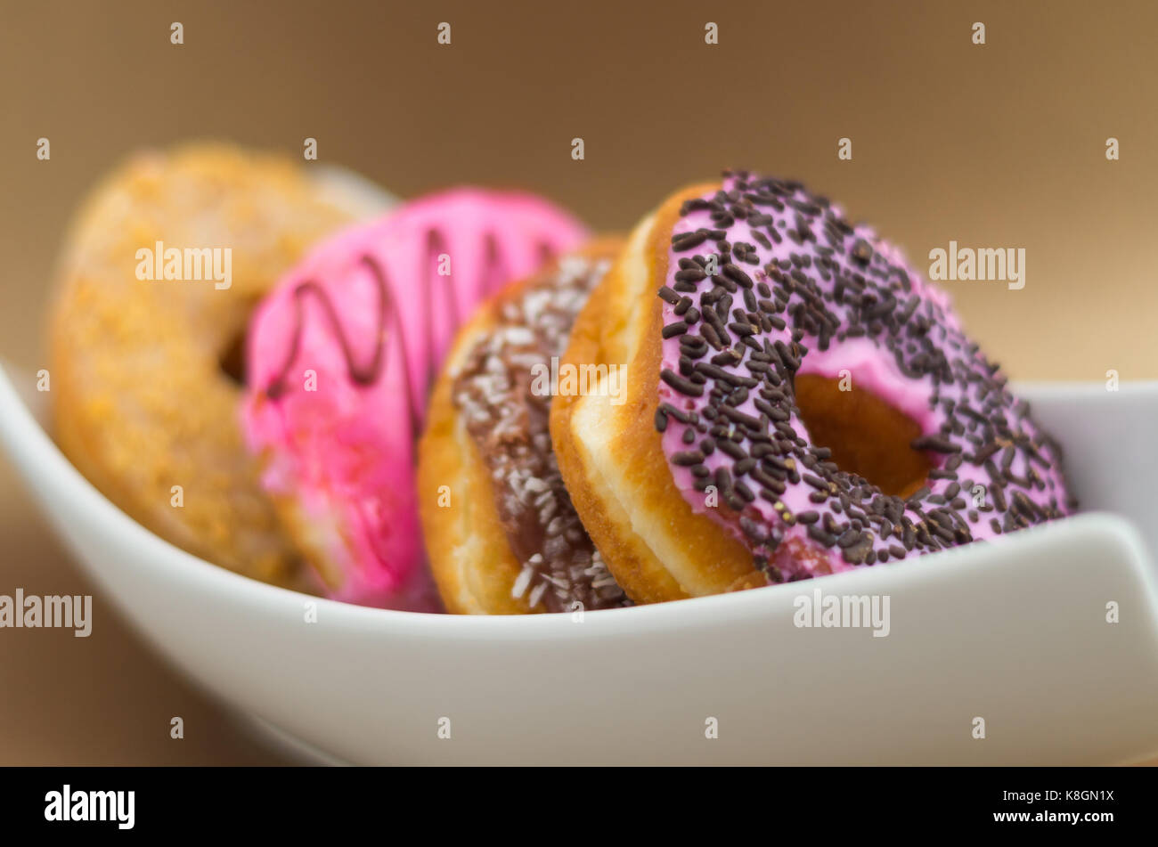 Delicious assorted donuts with chocolate frosted, pink glazed and ...