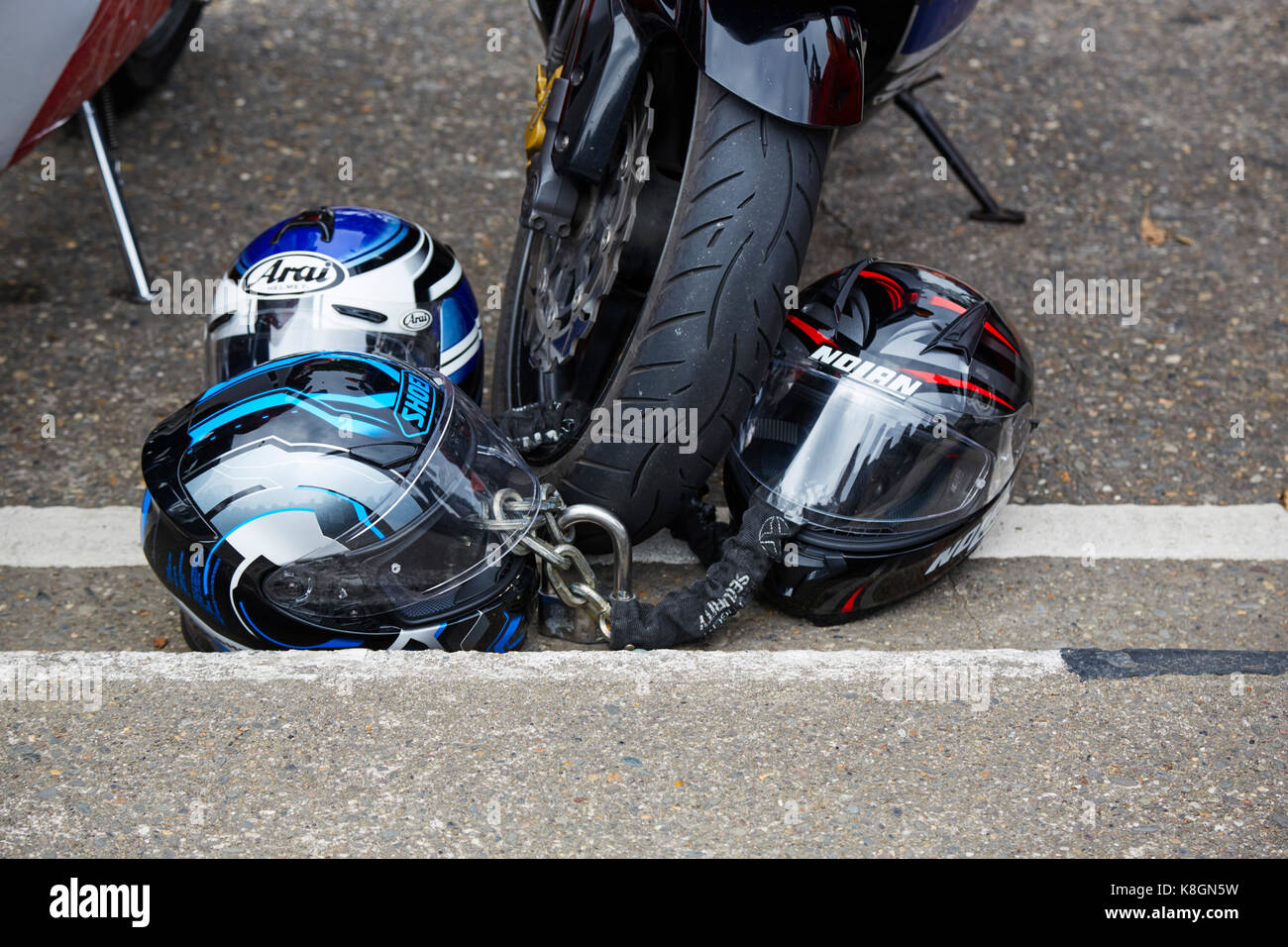Locking up helmets with bike Stock Photo